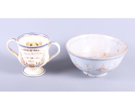 An 18th century Delftware bowl with orange decoration, 9" dia (damages) and a 19th century frog mug/loving, cup inscribed Joh