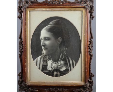 A 19th century photographic portrait of an unknown woman, in grained frame, and two other photographic portraits, framed and 