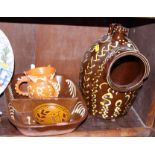 A slipware two-division dish, 11" wide, a similar three-handled tyg dated 1653, 3 1/2" high, and a