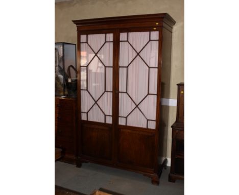 An Irish Georgian style line inlaid mahogany wardrobe enclosed two pink fabric backed astragal beaded glazed doors inset plai