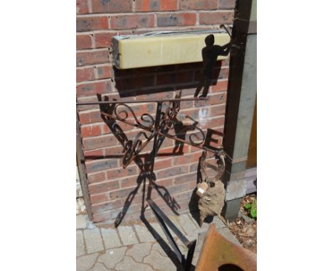 A golfing themed wrought iron weather vane.