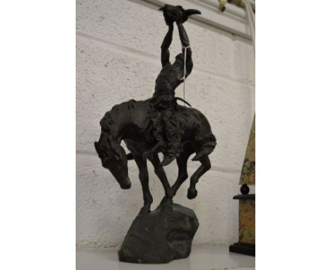 A bronze group depicting an Indian brave on horseback, possibly after an original by Remington.