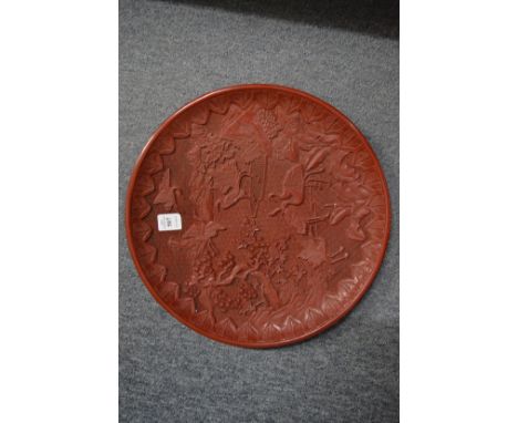 A large Chinese cinnabar lacquer style charger.