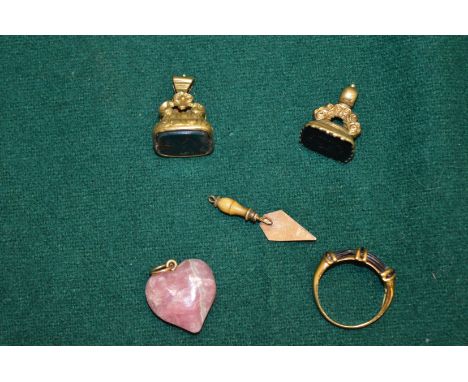 Two fob seals, miniature gold trowel, a ring and a pendant.