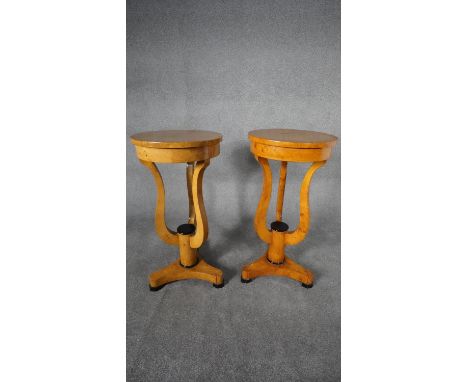 A pair of Biedermeier style burr maple lamp tables or urn stands on shaped supports resting on tripod platform base. H.84 