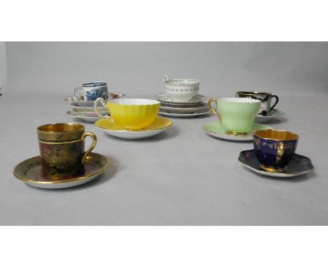 A collection of seven teacups and saucers and other saucers. Including a Fitz and Floyd orchid design cup and saucer, an anti