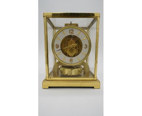 A Jaeger-LeCoultre Atmos clock, serial number 198242, the white enamel bezel applied with gilt metal Arabic numerals punctuat