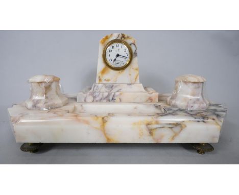 An Art Deco French veined marble desk set with clock, two ink wells and pen holder. The marble base is mounted on four gilded