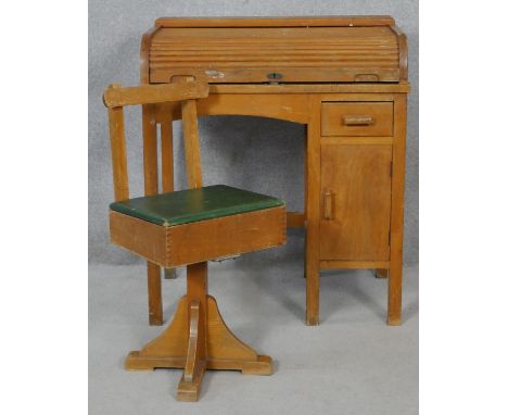 A vintage beech and ply child's desk with tambour roll top and the matching swivel desk chair. H.82 W.71 D.44cm 