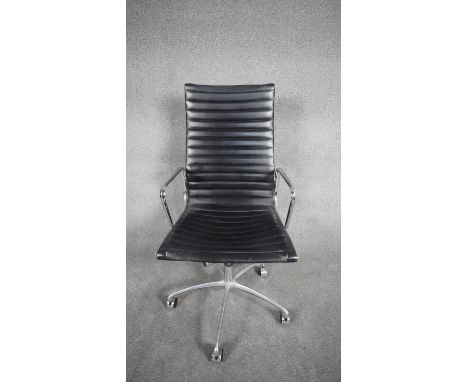 A Charles and Ray Eames inspired Aluminium Group desk chair with swivel and tilt action in black ribbed upholstery. H.116 