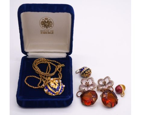 A boxed House of Faberge silver gilt royal blue enamel egg pendant on silver gilt rope chain, the pendant set with seven roun