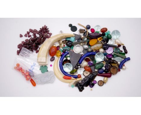 A large collection of loose gemstones and other minerals. Including coral beads, antique ivory tusks, carved jade pendant, ga