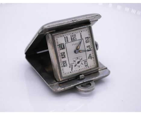 An Art Deco square metal Fiat Swiss ladies purse clock, with two dials and illuminated numbers, stamped 455, Swiss Made. Work