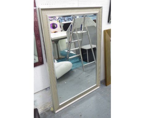 MIRROR, bevelled in a silvered ribbed frame, 130cm x 90cm.