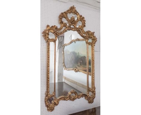 WALL MIRROR, Continental style gilt with 'C' scroll, leaf and flowerhead decoration, 79cm W x 131cm H.