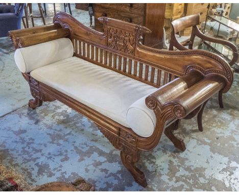 SETTEE, Colonial style teak with central carved animal decoration and a panelled seat having a loose cream patterned cushion 