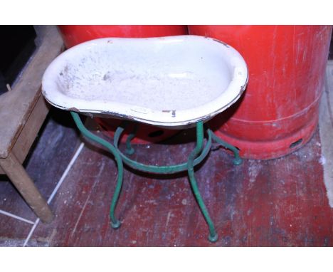An antique child's enamel bath on a wrought iron stand. postage unavailable 