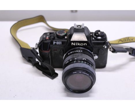 A vintage Nikon F-301 35mm camera and lens 