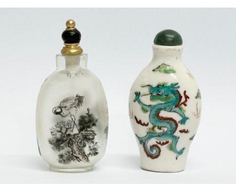 Two Chinese snuff bottles/scent bottles. A hand painted glass Zhou Leyuan style snuff bottle. An Early/Mid 20th Century paint