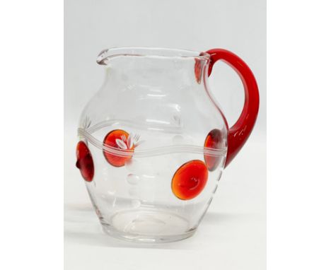A 1930’s water jug with ruby glass handle and etched glass ground. 17x14x16cm.
