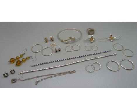 A collection of silver jewellery including earrings, a coin ring, bangle, two stone set bracelets, (tennis bracelet lacking s