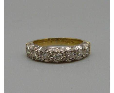 An 18ct gold, seven stone diamond ring, 4.4g, L 