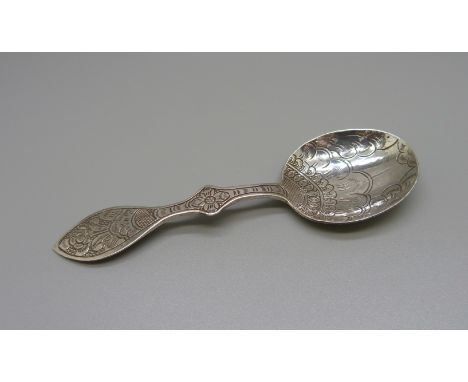 A decorative Arts and Crafts caddy spoon, tests as silver 