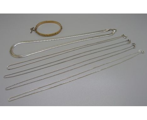 A silver necklace, four silver chains and a 1/5 9ct rolled gold children's bangle 