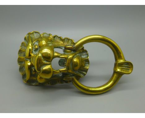 A lion's head brass door knocker 
