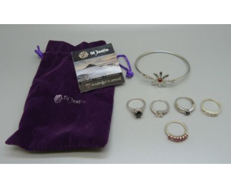 Five silver rings and a St. Justin bangle 