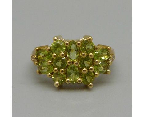 A silver gilt and peridot cluster ring, Q 