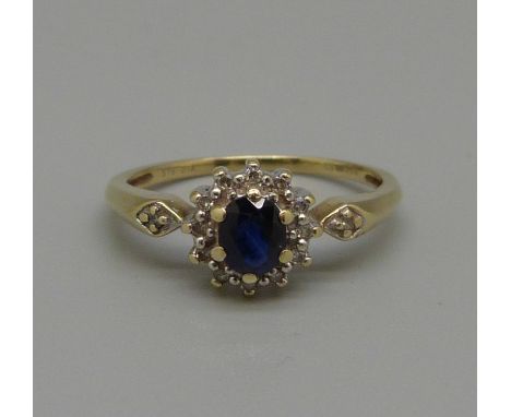 A 9ct gold, sapphire and fourteen stone diamond cluster ring, 1.6g, L 