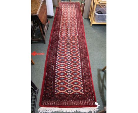 A Persian design carpet runner, red ground, 337cm x 78cm