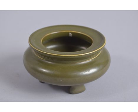 A CHINESE TEA DUST GLAZE TRIPOD CENSER, with character mark to base, 10cm diameter.