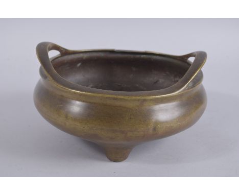 A LARGE CHINESE BRONZE TWIN HANDLE TRIPOD CENSER, the base with character mark, 23cm diameter.