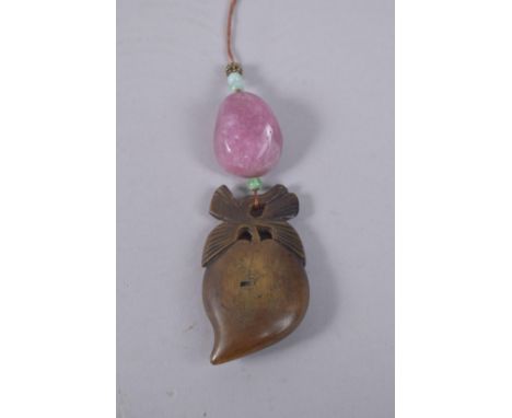 A CHINESE SIGNED CARVED HORN PENDANT WITH TOURMALINE AND JADE MOUNTS.