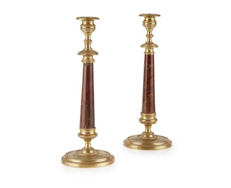 PAIR OF REGENCY GILT METAL AND ROUGE MARBLE CANDLESTICKS EARLY 19TH CENTURY the engine turned nozzles and drip trays above ta