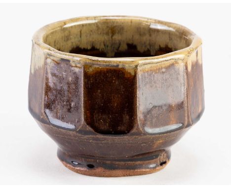 † MIKE DODD (born 1943); a faceted stoneware bowl covered in peat clay glaze with nuku rim, impressed MJD mark, diameter 14cm