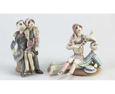 † HILARY BROCK (born 1933); two porcelain figures of couples in Edwardian costumes, one woman playing a banjo, painted B mark