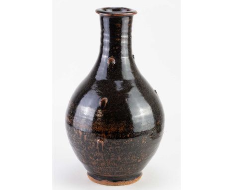 † JIM MALONE (born 1946); a stoneware Korean bottle covered in tenmoku breaking to kaki glaze with impressed decoration, impr