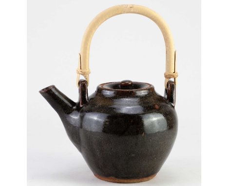 JIM MALONE (born 1946); a stoneware teapot with cane handle covered in tenmoku breaking to kaki glaze, impressed JM and L (fo