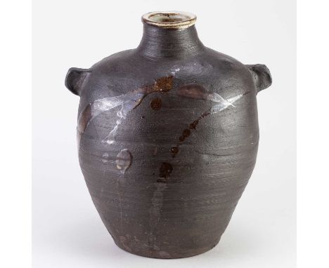 † JANET LEACH (1918-1997) for Leach Pottery; a large lugged black stoneware bottle with dolomite glaze to the rim and tenmoku