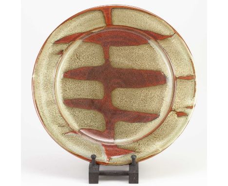 † RAY FINCH (1914-2012) for Winchcombe Pottery; a stoneware charger with kaki pours, impressed WP. mark, diameter 34cm.Condit