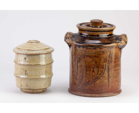 † MIKE DODD (born 1943); a ribbed stoneware caddy covered in nuka glaze, height 14cm, and a larger jar and cover covered in a