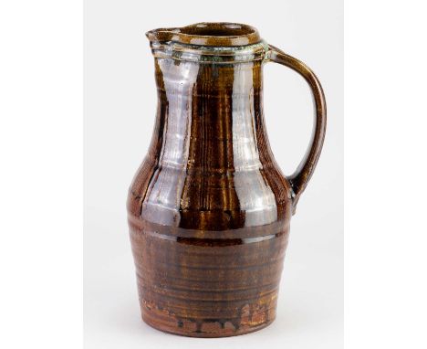 † MIKE DODD (born 1943); a tall stoneware pitcher covered in peat clay glaze with chun rim, impressed MJD mark, height 32.5cm