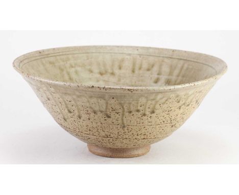 † JIM MALONE (born 1946); a stoneware bowl covered in running green ash glaze with incised decoration, impressed JM mark, dia