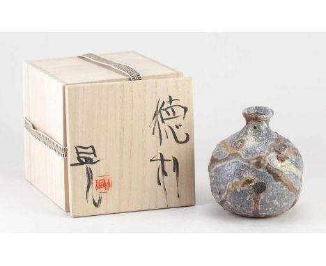 AKIRA SATAKE; a wood fired stoneware tokkuri, side fired on shells, height 12cm, with signed box.Akira Satake was born in Osa