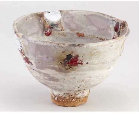 † ROBIN WELCH (1936-2019); a stoneware bowl covered in white and lilac glaze with red, white and black enamel decoration, imp