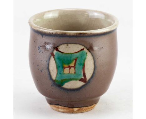 TATSUZO SHIMAOKA (1919-2007); a stoneware yunomi covered in kaki glaze with enamel decoration, incised mark, height 7.5cm.Tat