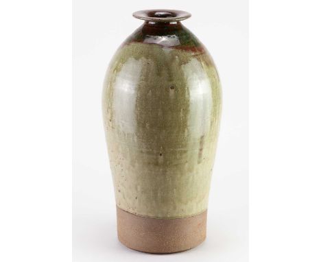 Leach Pottery; a tall stoneware bottle partially covered in green ash glaze with copper red and green top, impressed pottery 